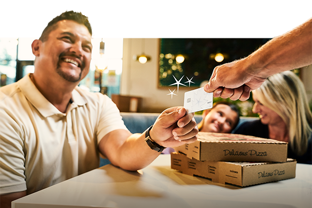 A customer paying for a meal with an OakStar Bank debit card.